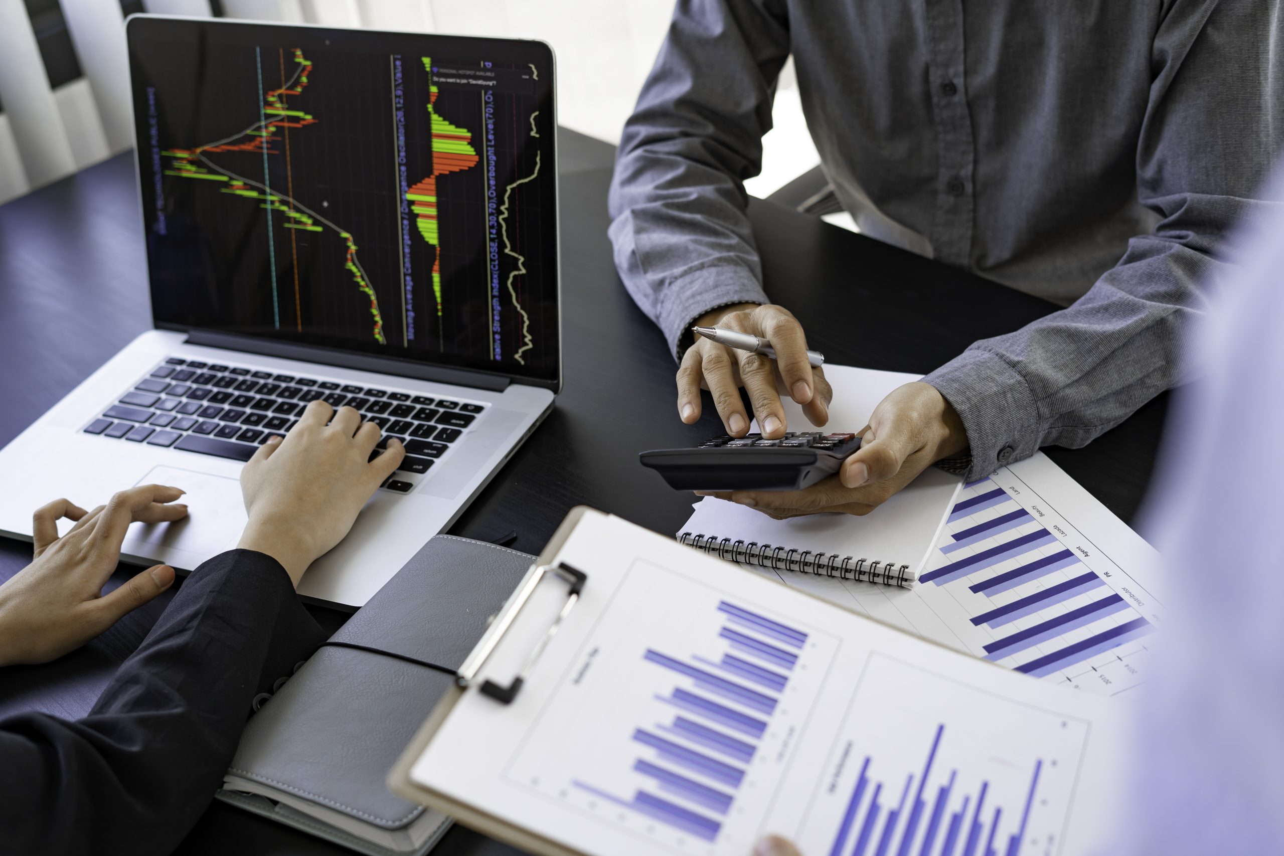 Two business partnership coworkers analysis strategy with discussing a financial planning graph and company budget during a budget for next year’s meeting in the office room.